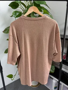 Detailed back view of a dusty pink loose ribbed knit mid-sleeve T-shirt for women