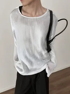 Detail view of men's loose white ribbed long-sleeve T-shirt with semi-sheer fabric.