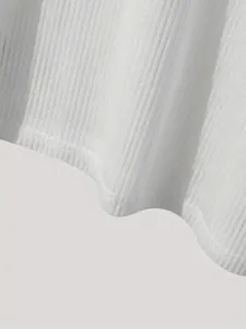 Detailed close-up showing the ribbed texture and hem of a white casual summer top.