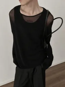 Detailed view of lightweight black mesh crew neck long sleeve top with loose fit styling