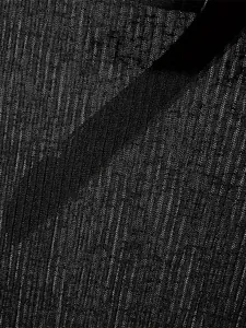 Close-up of lightweight black ribbed knit fabric showing mesh texture detail
