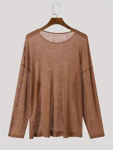 Macro detail of the sheer ribbed texture on this brown round neck long sleeve top.