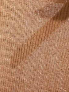 Close-up macro detail of premium lightweight brown ribbed knit fabric for a summer top