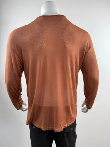 Back view of a lightweight ribbed rust-orange long sleeve shirt with drop shoulders