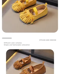 Detailed close-up of kids' suede tassel Mary Jane princess flats in yellow and brown