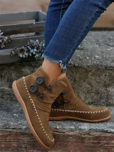 Side view of brown suede ankle boots featuring decorative stitching and buttons