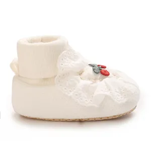 Close-up of white baby princess shoe featuring lace trim and a cute cherry embroidery.