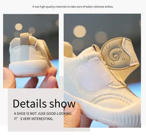 Close-up macro view of breathable mesh fabric and adjustable strap on white baby walking shoes