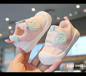 Close-up of pink baby walking shoes with breathable mesh and cute snail velcro