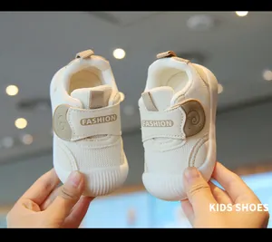 Close-up view of breathable mesh baby walking shoes with soft soles and velcro strap.