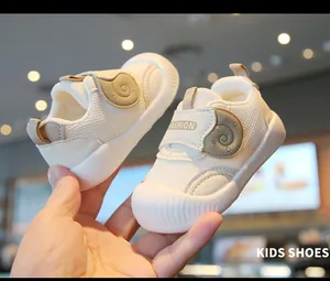 Close-up of white mesh toddler walking shoes with breathable design and soft sole.