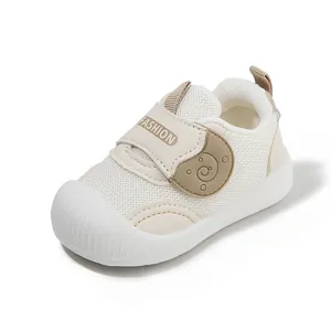 Breathable white and beige mesh baby walking shoes with soft soles and velcro strap fastening