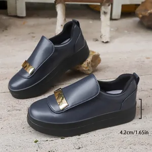 Detail showing the 4.2cm thick platform sole on dark grey loafers with a gold buckle
