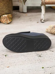 Macro detail showing the anti-slip diamond pattern on the thick rubber sole of the shoe