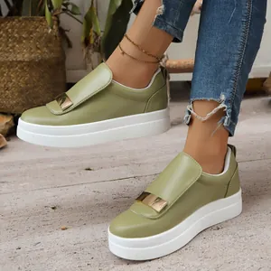 Detailed side view of light green platform slip-on shoes with metallic buckle accents.