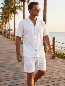Detailed lifestyle view of men's white waffle knit button shirt and shorts set.