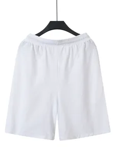 Macro view of white linen fabric on men's casual beach shorts with elastic waistband