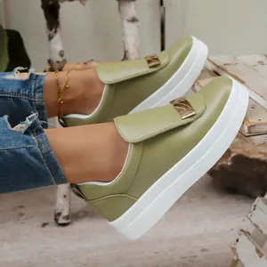 Close-up of stylish olive green platform slip-on shoes with elegant gold buckle detail