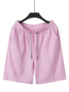 Detailed texture shot of pink linen drawstring beach shorts for men's summer beachwear