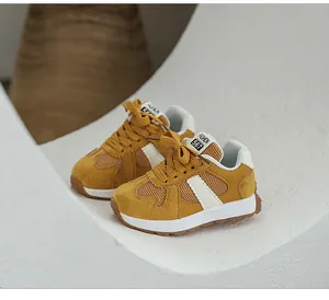 Close-up detail of mustard yellow breathable mesh German training sneakers with thick soles