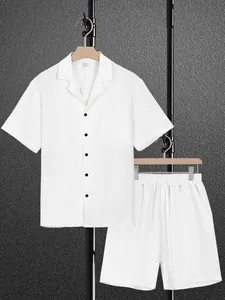Detailed view of white textured short-sleeved shirt and matching shorts on hangers