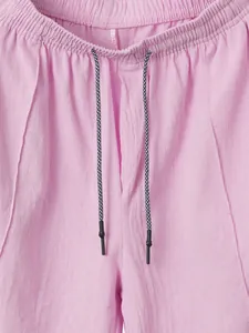 Detailed macro shot of pink linen men's summer shorts with elastic waist and drawstring