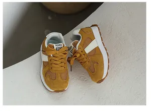 Detail of mustard yellow suede and mesh toddler sneakers with white platform soles