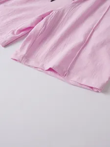 Close-up of pink linen men shorts leg showing fabric texture and hem stitching detail