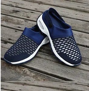 Detail view of navy blue mesh rocking sandals with thick white air-cushioned soles