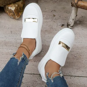 Stylish white platform sneakers for women featuring an elegant gold metallic bar detail