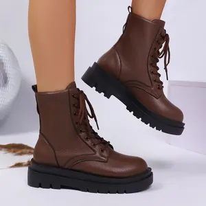 Side detail of brown pebbled leather combat boots featuring thick black platform soles