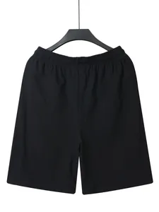 Close-up front view of men's black linen casual shorts with elastic waistband design