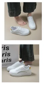 Gros plan sur les baskets blanches compensées pour femmes avec détails dorés chic.