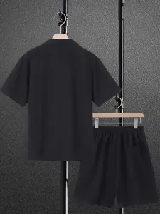Back view of a men's casual black short sleeve shirt and matching shorts set on hangers