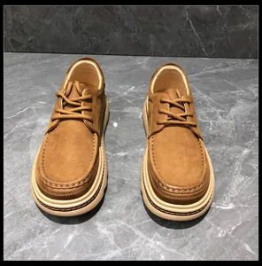 Detailed view of men's brown leather work shoes with thick soft soles and stitching