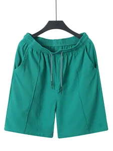 Detailed front view of green men's casual linen shorts featuring elastic drawstring waist