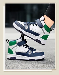 Macro view of boys' high-top waterproof sneakers in navy blue and green colorway.