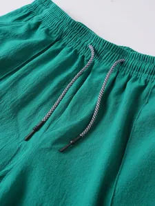 Close-up of elastic waistband and striped drawstring on men's linen beach shorts