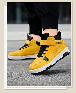 Close-up detail of boys high-top yellow leather sneakers with anti-slip sole.