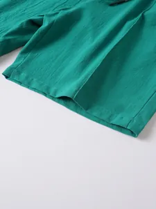 Detailed close-up of men's teal linen shorts showing fabric texture and hemline