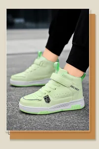 Close-up of boys' light green high-top sneakers with durable waterproof leather surface