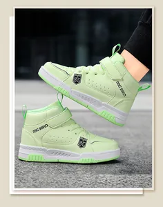Close-up detail of light green boys high-top skate shoes featuring waterproof leather