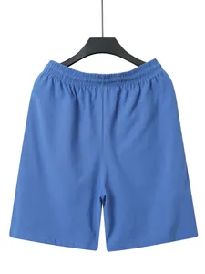 Detailed view of men's blue linen-style shorts with an elastic waistband.