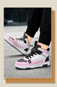 Detailed view of pink and white boy's high-top leather sneakers on a paved path