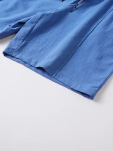 Macro view of blue linen men's shorts showing breathable fabric and hem detail