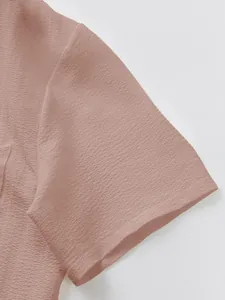 Detail shot of men's pink short sleeve shirt featuring breathable textured fabric