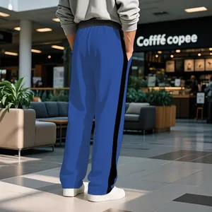 Back view of blue men's heavy cotton sweatpants with black side stripes Detail view
