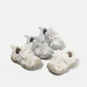 Elegant baby girl toddler shoes with pearls and bows in ballet style