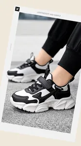 Eine stilvolle Seitenansicht von leichten Jungen-Laufschuhen in Schwarz und Weiß