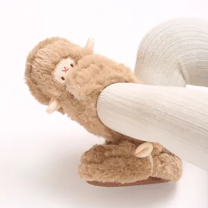 Gros plan de chausson bébé en peluche marron en forme d'agneau avec semelle antidérapante